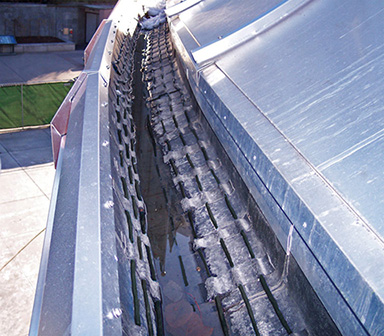 Self-regulating roof heating cable 
		installed in commercial gutter.